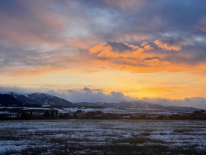 Orange sunset over snowy mountains